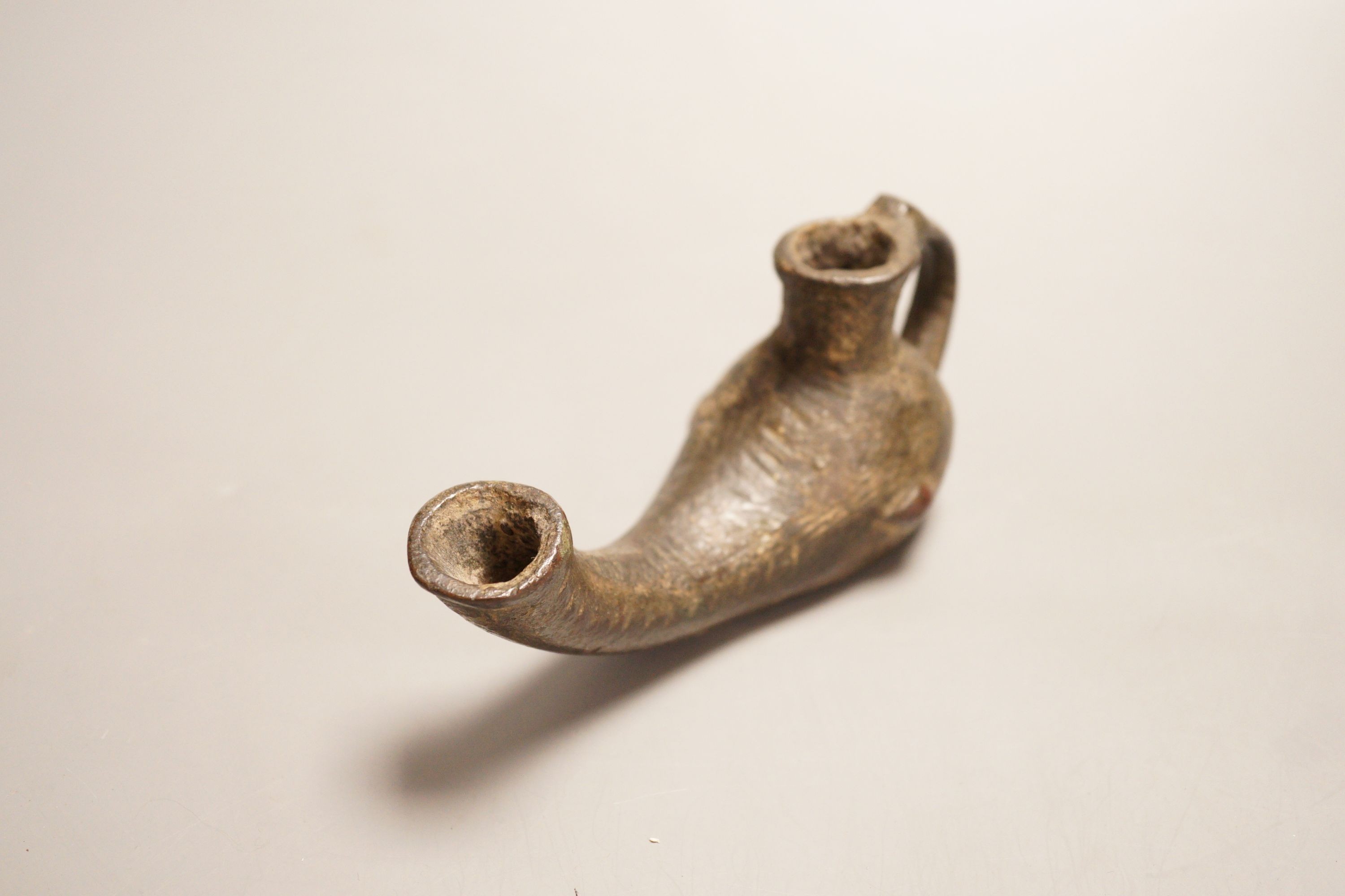 An early bronze oil lamp, probably Byzantine, 16cm long